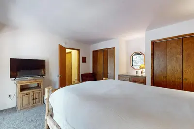 a bedroom with a bed and a flat screen tv at High Meadows Retreat in South Lake Tahoe