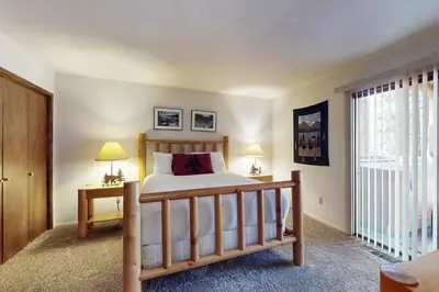 a bedroom with a bed and two lamps and a window at High Meadows Retreat in South Lake Tahoe