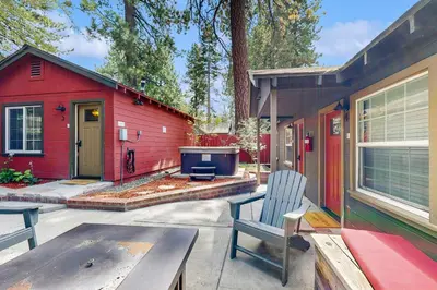 a red house with a bench in front of it at Manzanita Holiday 5 in South Lake Tahoe