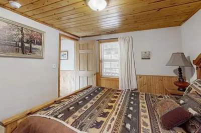 a bedroom with a bed in a room with a wooden ceiling at Hank Monk Manor in South Lake Tahoe