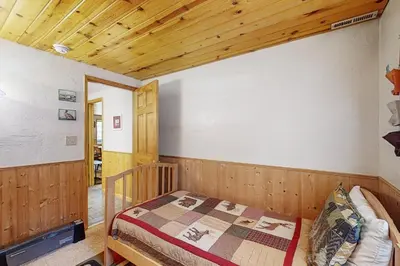 a bedroom with a bed and a wooden ceiling at Hank Monk Manor in South Lake Tahoe