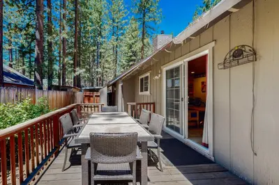 a deck with a wooden table and chairs at Hank Monk Manor in South Lake Tahoe