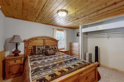 a bedroom with a bed and a wooden ceiling at Hank Monk Manor in South Lake Tahoe