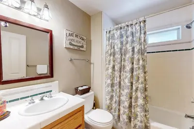 a bathroom with a sink and a toilet and a mirror at Gold Dust Escape in South Lake Tahoe