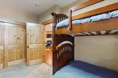 a bedroom with two bunk beds and a closet at Wagon Wood Retreat in South Lake Tahoe