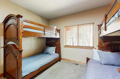 a bedroom with two bunk beds and a window at Wagon Wood Retreat in South Lake Tahoe