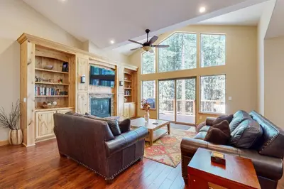 a living room with a couch and a table at Wagon Wood Retreat in South Lake Tahoe