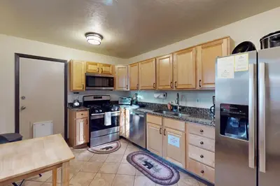 a kitchen with wooden cabinets and stainless steel appliances at Genoa Haven in South Lake Tahoe