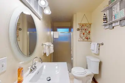 a bathroom with a sink and a toilet and a mirror at Genoa Haven in South Lake Tahoe