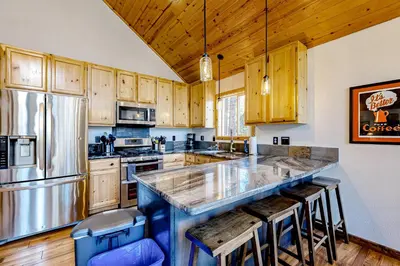 a kitchen with wooden cabinets and a large counter top at Lausanne Getaway in Truckee