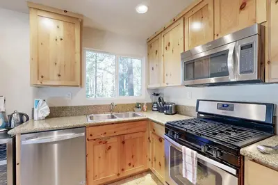 a kitchen with stainless steel appliances and wooden cabinets at Miztec Manor in South Lake Tahoe