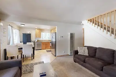 a living room with a couch and a table and a kitchen at Miztec Manor in South Lake Tahoe