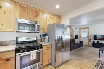 a kitchen with stainless steel appliances and wooden cabinets at Miztec Manor in South Lake Tahoe