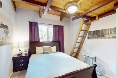 a bedroom with a bed with purple curtains and a ladder at Ski Run Village in South Lake Tahoe