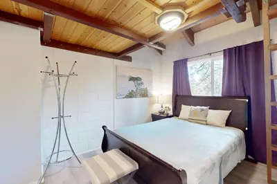 a bedroom with a large bed with a wooden ceiling at Ski Run Village in South Lake Tahoe