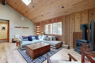 a living room with a couch and a tv at Westshore Oasis in Tahoma