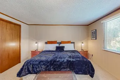 a bedroom with a large bed and two night stands at Sky Meadows Charmer in South Lake Tahoe