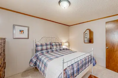 a bedroom with a bed and a mirror at Sky Meadows Charmer in South Lake Tahoe