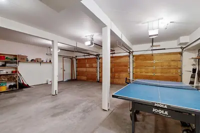 an empty room with a ping pong table in it at Schussing Paradise in Truckee