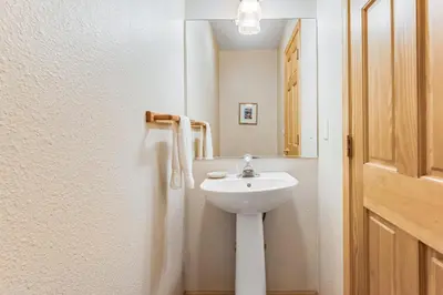 a bathroom with a white sink and a mirror at Falcon Point Manor in Truckee