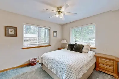 a bedroom with a bed and a ceiling fan at Oregon Oasis in South Lake Tahoe