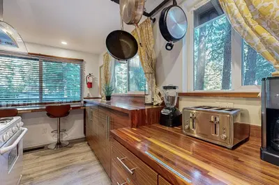 a kitchen with wooden counters and windows and a stove at Charming Lake Tahoe Cabin in Carnelian Bay