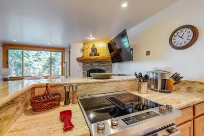 a kitchen with a stove and a clock on the wall at Coyote Fork 4051 in Truckee