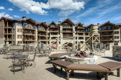 a resort with a fire pit and tables and chairs at Coyote Fork 4051 in Truckee