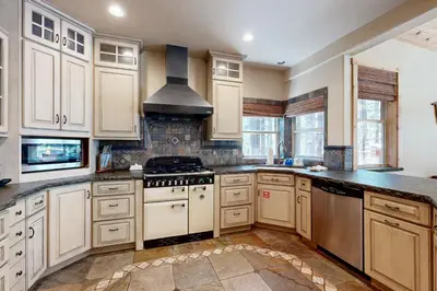a kitchen with white cabinets and a stove top oven at Oslo Manor in Truckee