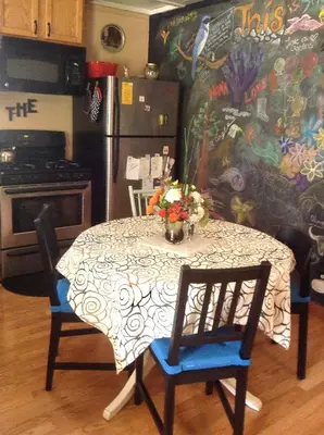 a kitchen with a table and chairs and a refrigerator at Fivespot Cabin in Pinehurst