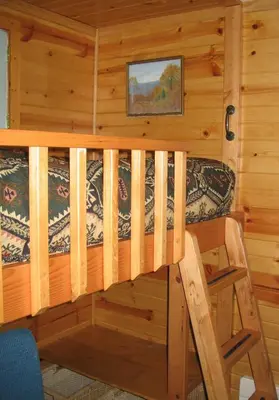 a cabin with a bed and a chair in it at Fivespot Cabin in Pinehurst