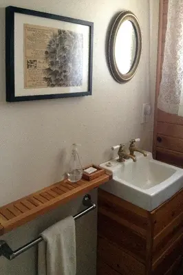 a bathroom with a sink and a mirror at Fivespot Cabin in Pinehurst