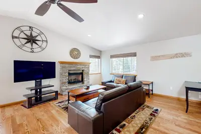 a living room with a couch and a flat screen tv at Sunlit Forest Haven in South Lake Tahoe