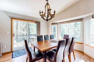 a dining room with a wooden table and chairs at Sunlit Forest Haven in South Lake Tahoe