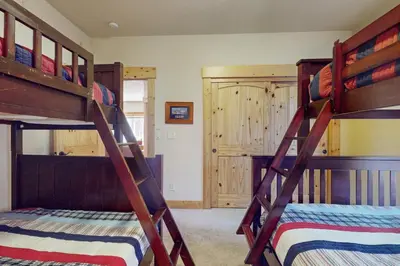 two bunk beds in a room with a bed at West Shore Retreat in Tahoma