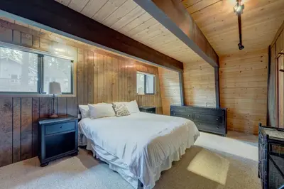 a bedroom with a bed in a wooden room at Dollar Point in Tahoe City