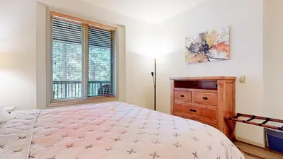 a bedroom with a bed and a dresser and a window at Mammoth Green 118 Located on Sierra Star Golf Course, Private Patio, Summer Pool condo in Mammoth Lakes