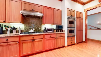 a large kitchen with wooden cabinets and appliances at Lodestar #2001 home in Mammoth Lakes