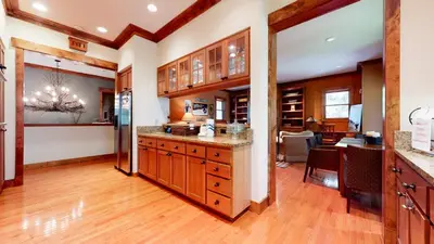 a kitchen with wooden cabinets and a dining room at Lodestar #2001 home in Mammoth Lakes