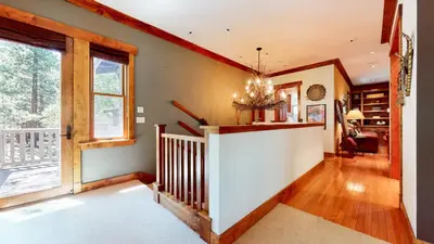 a living room with a staircase and a window at Lodestar #2001 home in Mammoth Lakes