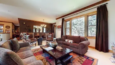 a living room with couches and a table at Lodestar #2001 home in Mammoth Lakes