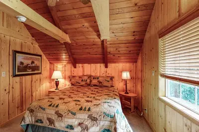 a bedroom with a bed in a log cabin at Dollhouse in Arnold