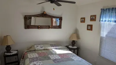 a bedroom with a bed and a mirror on the wall at Room #3 at the Apple Place in Miramonte