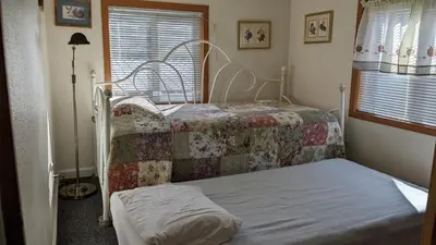 a bedroom with two beds and a window at Room #3 at the Apple Place in Miramonte