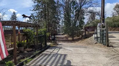 an entrance to a park with a gate and trees at Room #3 at the Apple Place in Miramonte