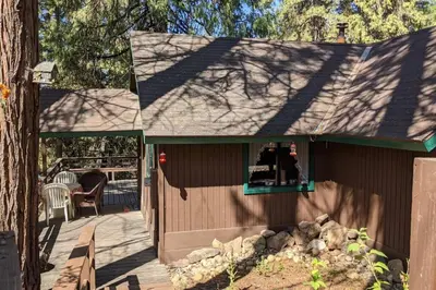 a small house with a window on a deck at Pierce's Cabin in Miramonte