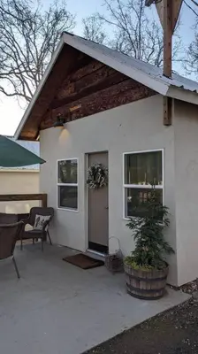 a small white house with a table and a chair at Cozy Cabin in Squaw Valley