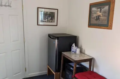 a corner of a room with a black refrigerator at The Apple Place Room #2 in Miramonte