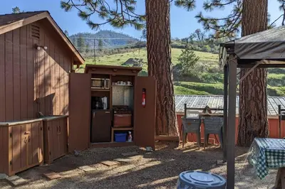 a smallshed with a kitchen and a table in a yard at The Apple Place Room #2 in Miramonte
