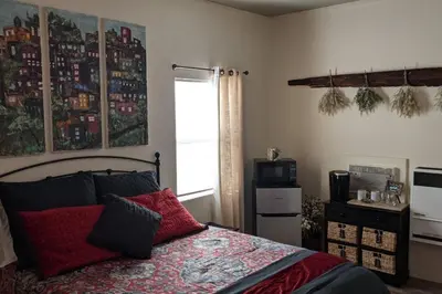 a bedroom with a bed with a red blanket and a window at Sweet Mountain Cabin in Squaw Valley